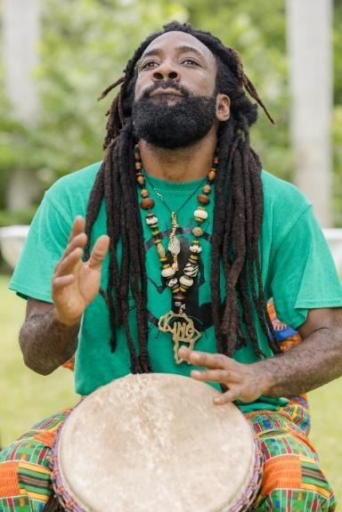 A picture containing person, outdoor, grass, drum

Description automatically generated
